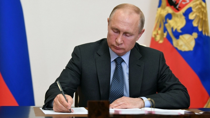 Putin signs bill allowing him 2 more presidential terms
